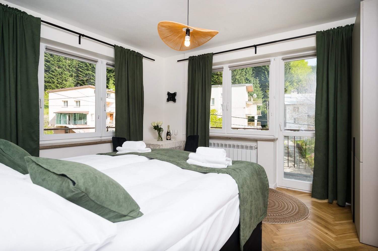Apartament typu Classic (3) — sypialnia z zielonymi zasłonami i widokiem na góry